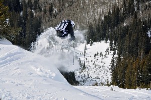 Backcountry Skier launches off a pillow of snow